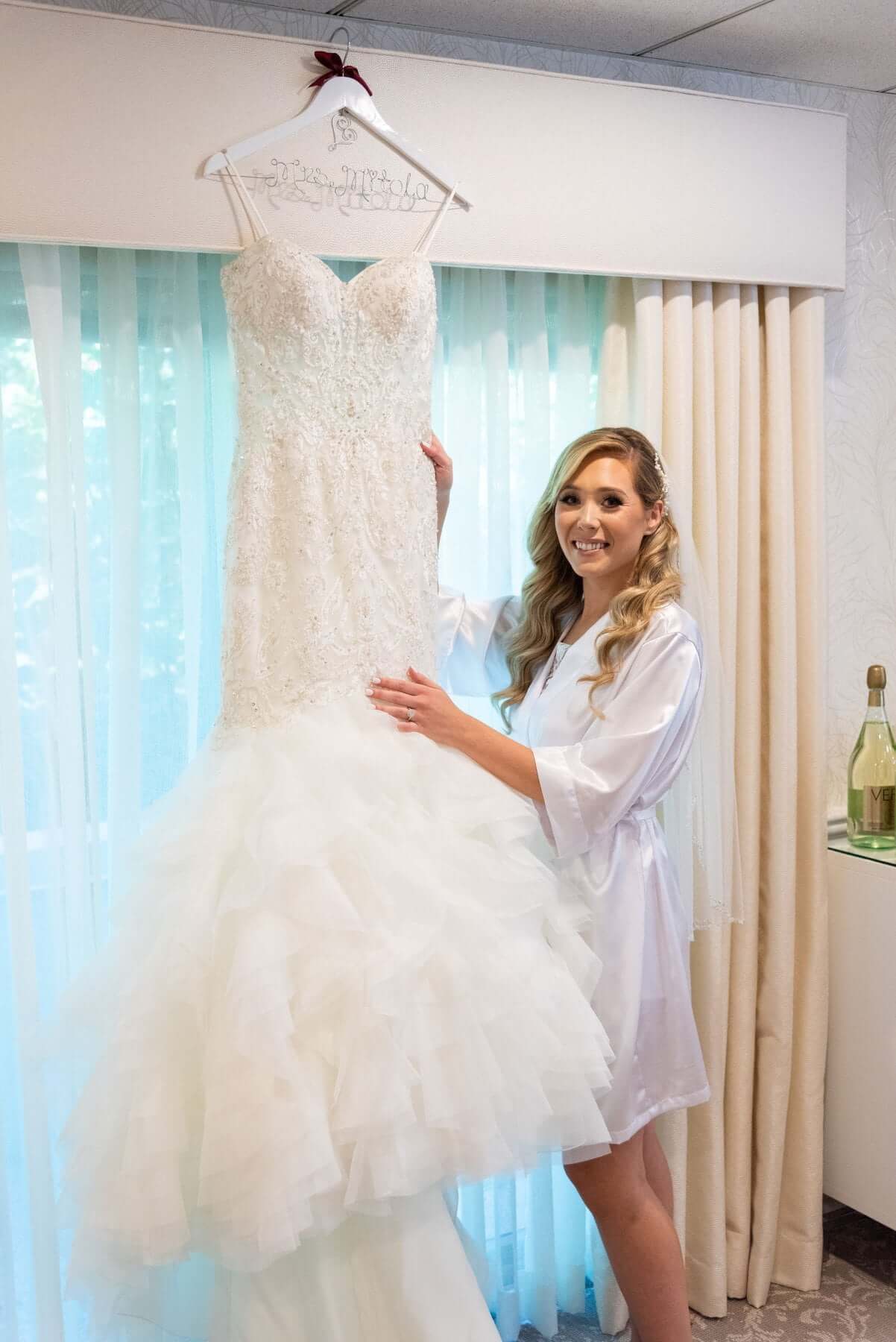 118739257_1075592436177106_401008454688678031_n A bride posing with her wedding dress in a elegant hotel room at one of the top-notch New Jersey wedding venues.