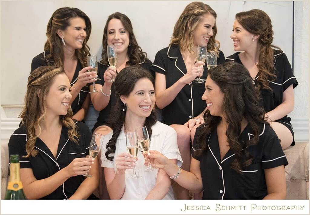 A group of bridesmaids toasting with champagne glasses at beautiful outdoor wedding venue in New Jersey.