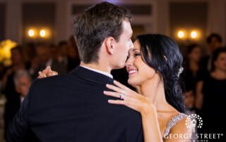 A bride and groom sharing their first dance at an outdoor wedding reception in one of the stunning New Jersey wedding venues.