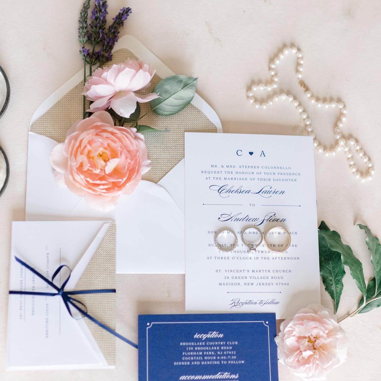 Navy wedding invitations adorned with elegant flowers and delicate pearls, perfect for couples celebrating their special day in charming New Jersey venues. These exquisite invitations capture the essence of a romantic Florham Park wedding, offering
