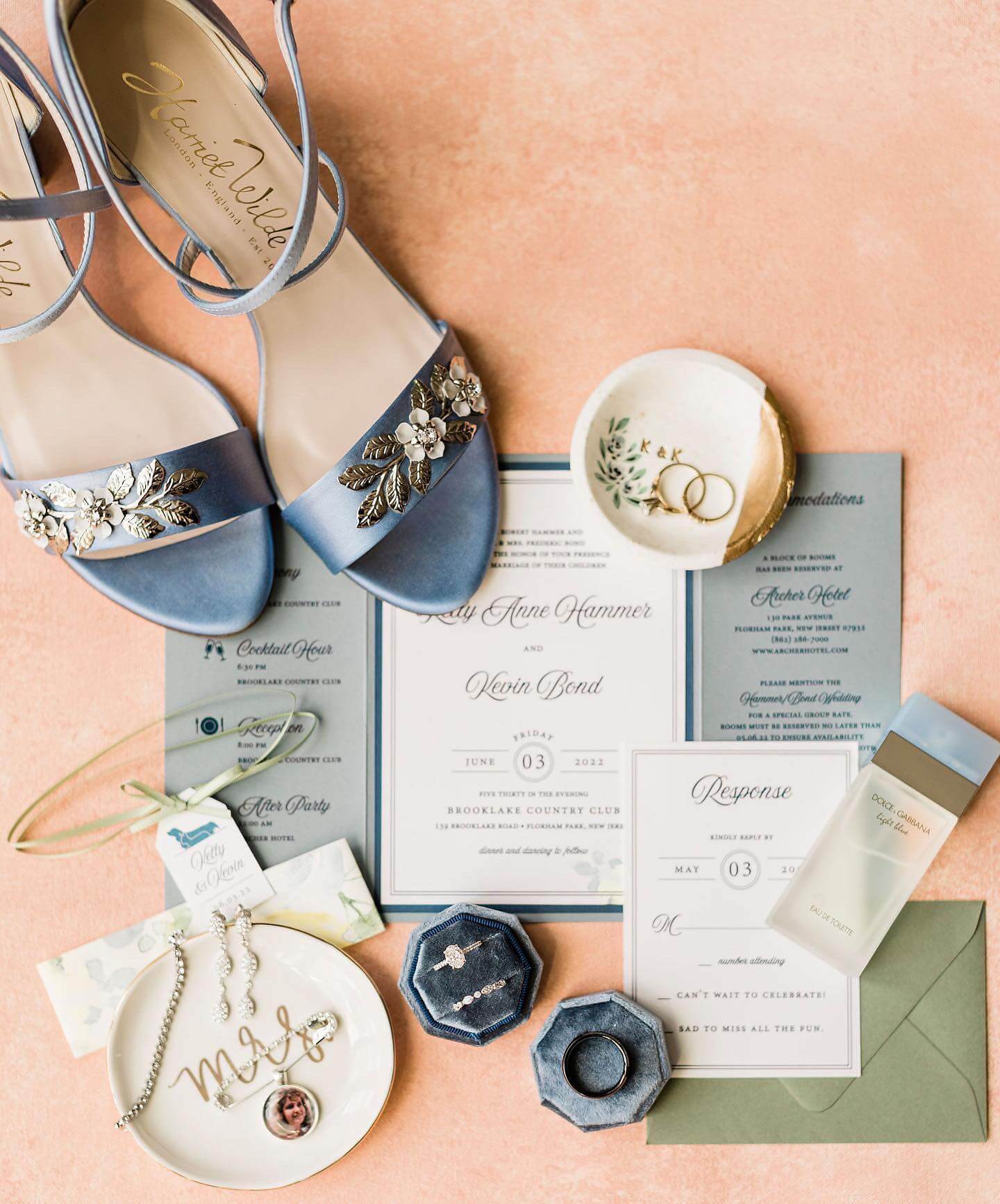 Wedding invitations, shoes, and jewelry beautifully presented on a table at a New Jersey wedding venues.