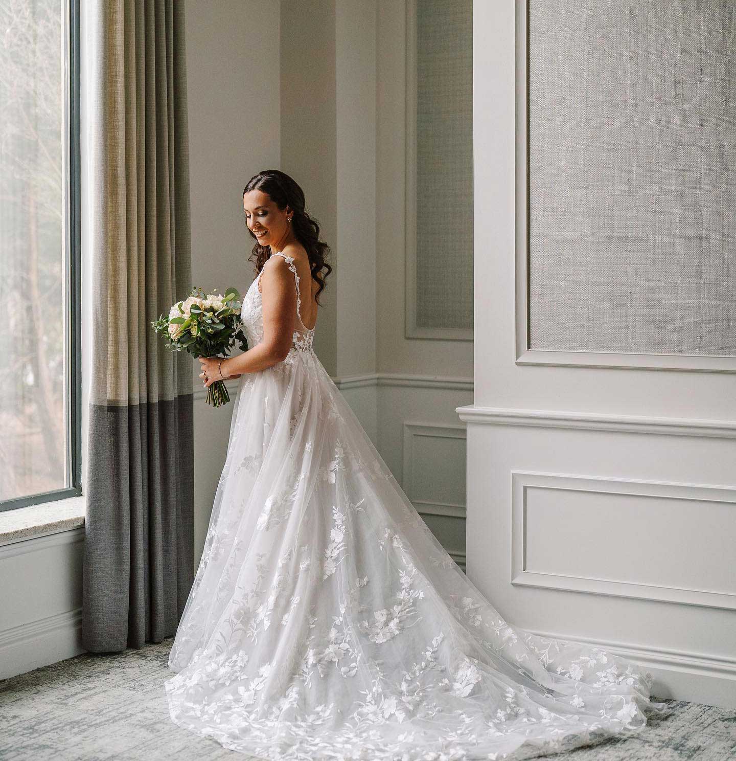 springtime-bride A bride in a wedding dress standing in front of a window at one of the exquisite New Jersey wedding venues.