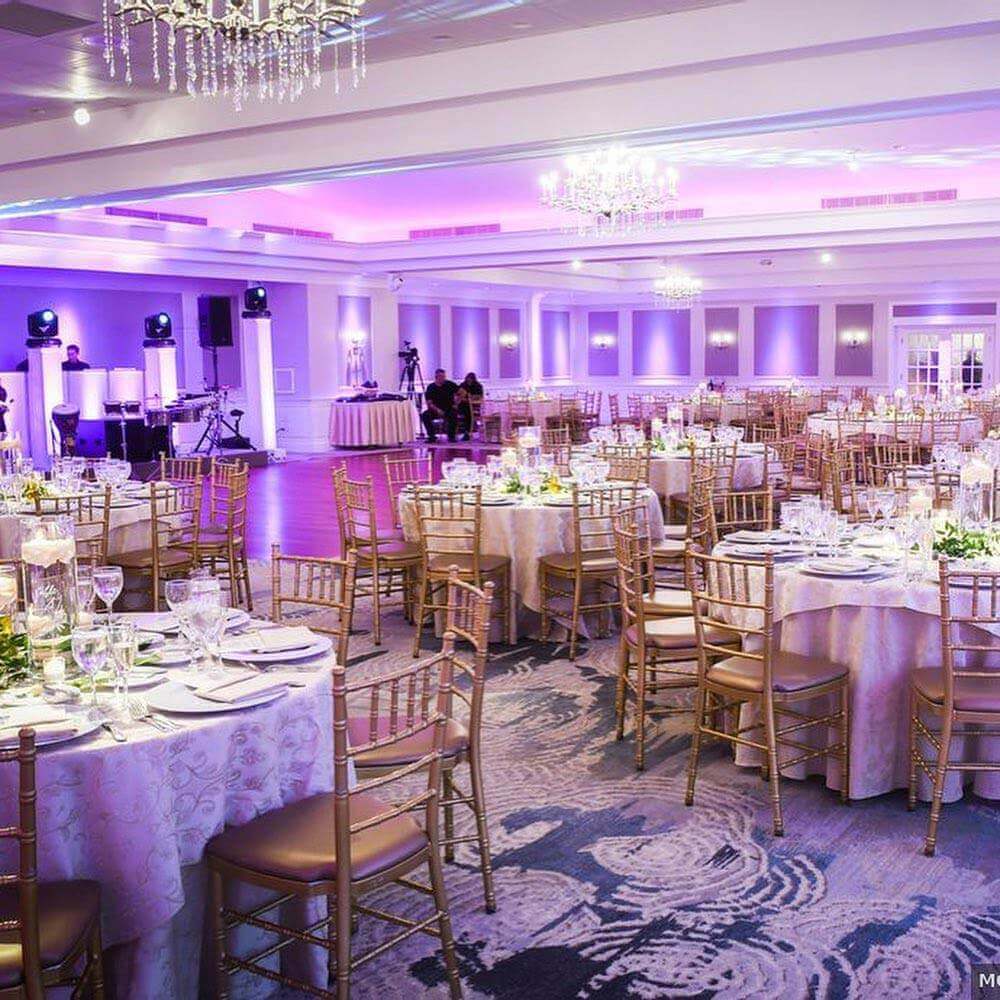 brooklake-ballroom Elegant banquet hall set up for kosher weddings in NJ, with tables, chairs, and mood lighting.
