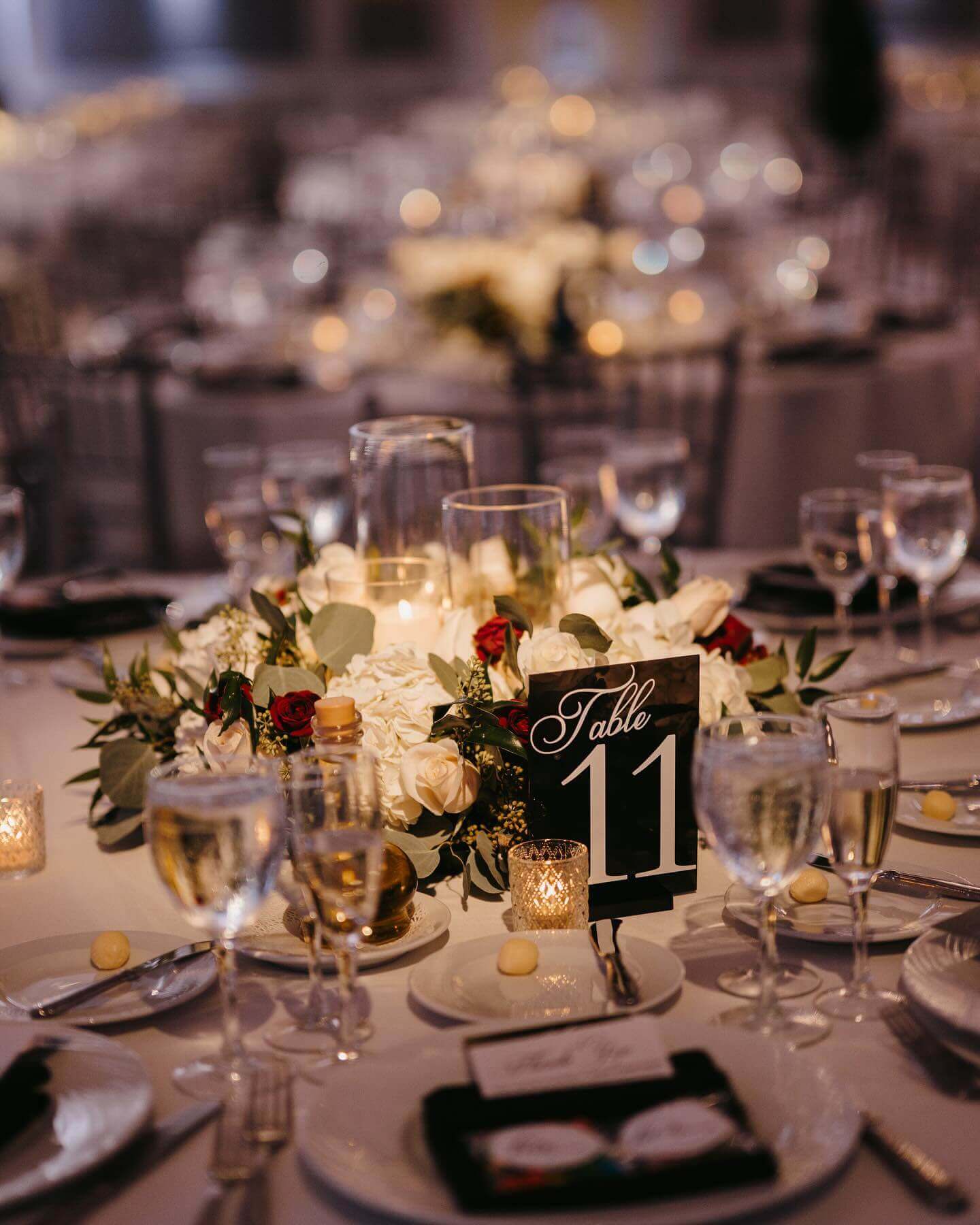 Elegant table setting for kosher weddings in NJ with floral centerpiece and table number.