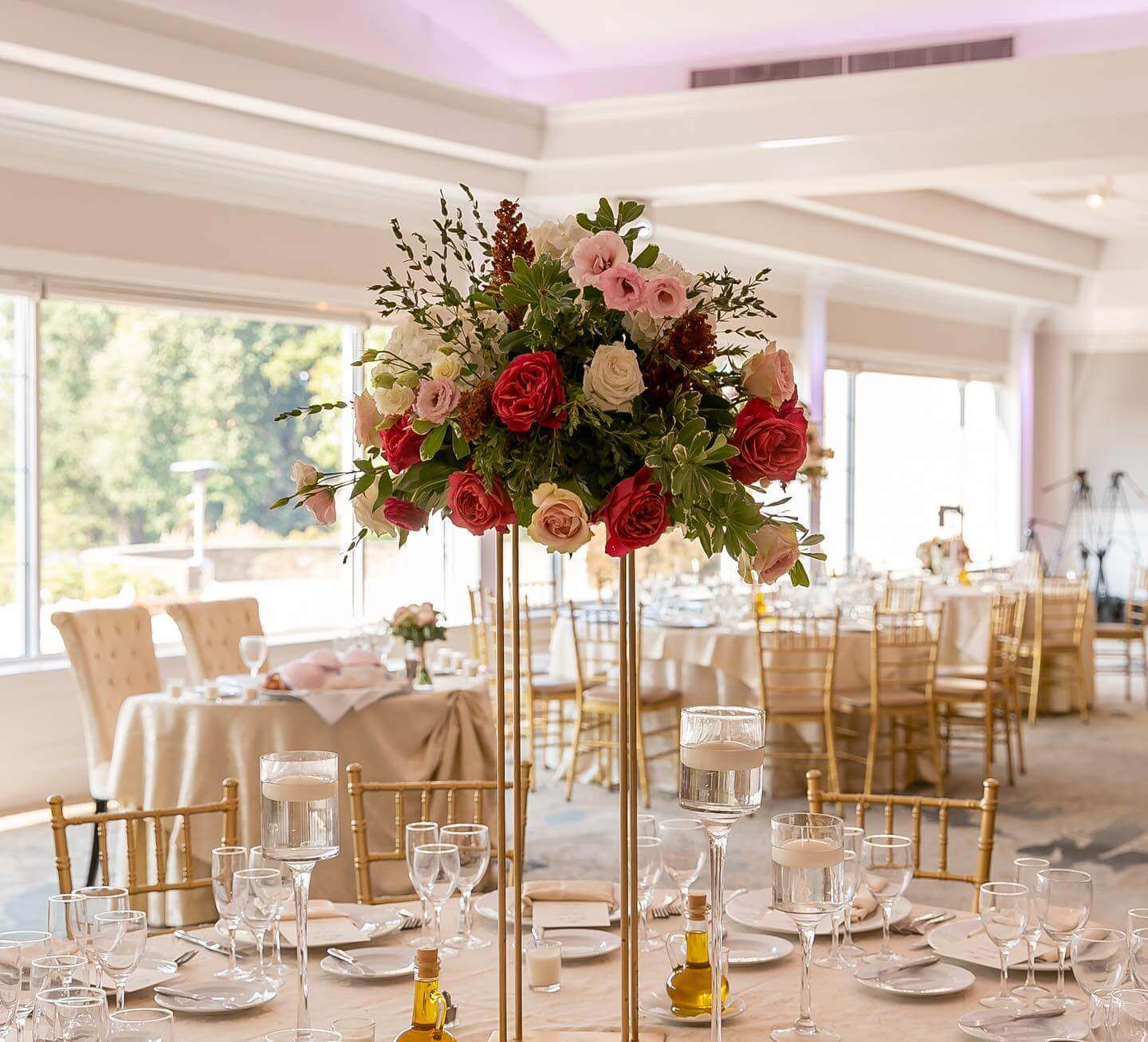 high flowers at wedding table Elegant table setting with a tall floral centerpiece in a kosher wedding banquet hall in NJ.